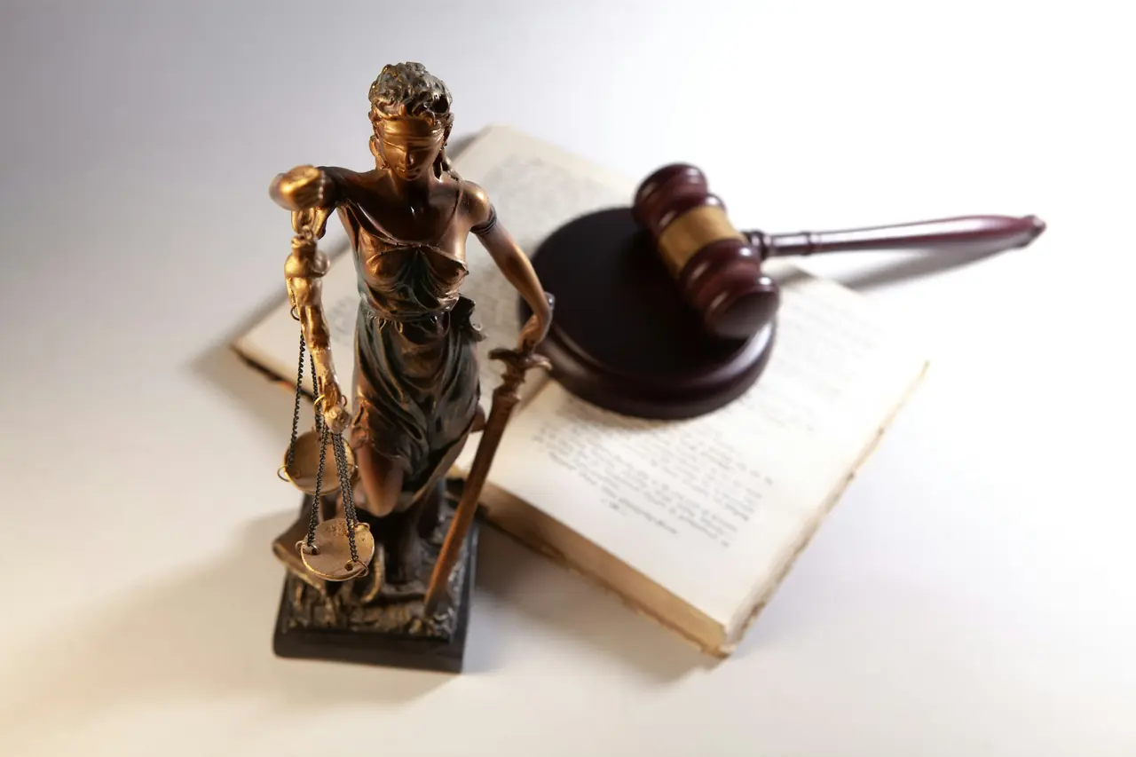 Statue of Lady Justice with a gavel and an open book